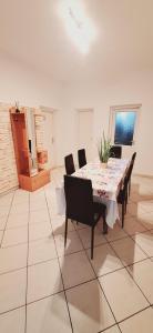 a dining room with a table and chairs at Levu Lak in Kapuvár