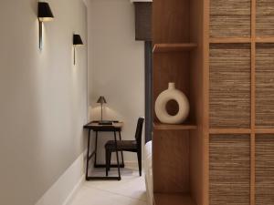 a bedroom with a desk and a chair next to a door at The Chedi El Gouna in Hurghada