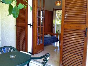 a room with a table and a room with a bed at Akrata Golden Beach House in Aíyira +135 photos