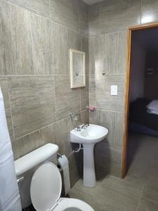 a bathroom with a toilet and a sink at OMA Departamentos por día -1 in General Acha