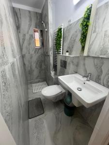 a bathroom with a sink and a toilet at Emmaia Escape Eforie Nord in Eforie Nord +26 photos