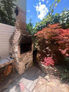an outdoor brick oven in a yard with plants at Emmaia Escape Eforie Nord in Eforie Nord