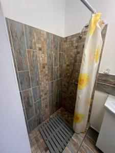 a shower in a bathroom with a shower curtain at Emmaia Escape Eforie Nord in Eforie Nord +11 photos