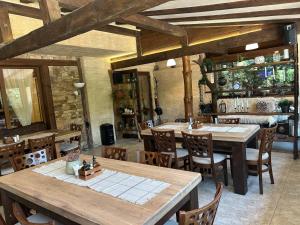 a dining room with wooden tables and chairs at Villa Ema in Panichishte