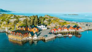 an aerial view of a village on an island in the water at Reinefjorden Sjøhus in Reine +134 photos