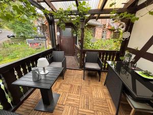 a balcony with a table and chairs and a view at Kleiner Kalle in Melsungen +15 photos