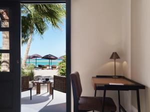 an office with a desk and a view of the beach at The Chedi El Gouna in Hurghada
