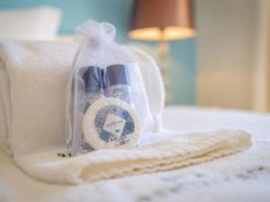 a bag of toothbrushes sitting on a bed at Relax and golf at Boavista Golf Spa Resort #1968 in Lagos