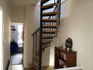 a spiral staircase in a living room with a book shelf at Bridge Villas in Garstang +7 photos