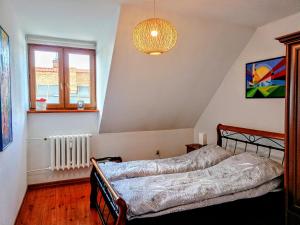 a bedroom with a bed and a chandelier at Kazimierz City Center Senatorska in Kazimierz Dolny