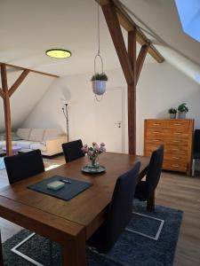una sala da pranzo con tavolo e sedie in legno di Zentrale Wohnung, Haustiere- und Kinderfreundlich a Weener
