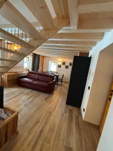 a living room with a couch and a table at La casa di Nil - Appartamento Orso in Spiazzo