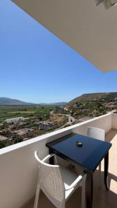 a table and chairs on a balcony with a view at Inscape Apartments in Sarandë