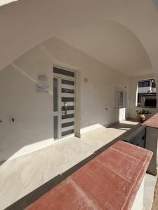 a kitchen with white walls and an open door at Casa Lucia in Calabernardo