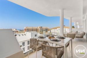 a white table and chairs on a balcony with a view at Mimosa in Fuengirola