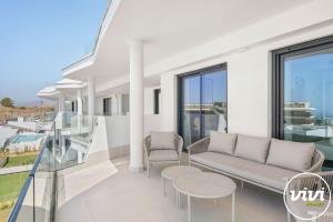 a living room with a couch and chairs on a balcony at Mimosa in Fuengirola