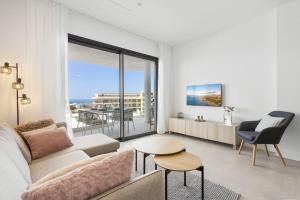 a living room with a couch and a table at Mimosa in Fuengirola