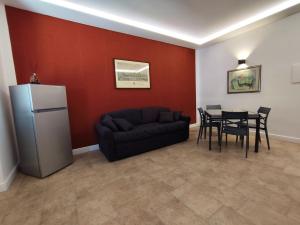a living room with a black couch and a table at La Pietra 1911 in Ercolano
