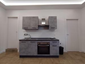 an empty kitchen with a sink and a stove at La Pietra 1911 in Ercolano