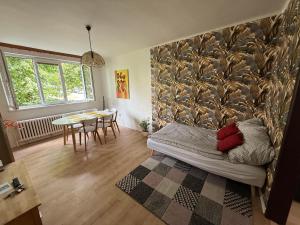 a small room with a bed and a table at Apartmán JzP in Jihlava