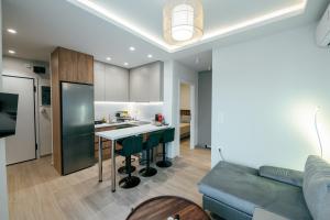 a kitchen and living room with a couch and a table at The viewpoint loft in Korinthos