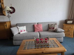 a living room with a couch and a coffee table at Le Serac Panoramic Mountain View spacious 40m2 managed by private host in Val Thorens