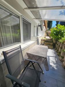 a patio with a table and a chair on a porch at Wohnung Hochbild in Überlingen