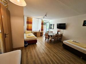 a room with a bed and a dining room with a table at Wohnung Hochbild in Überlingen