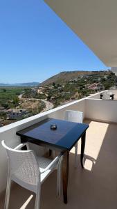 a blue table and two white chairs on a balcony at Inscape Apartments in Sarandë