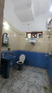 a bathroom with a toilet and a sink at Peace in city, home of greenary Grand Journey Venue in Darbhanga