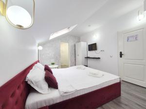 a bedroom with a large bed with a red headboard at Pensiunea ober in Braşov +157 photos