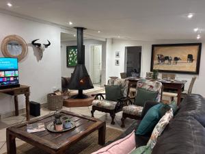 a living room with a couch and a table at DullVino Wellington House in Dullstroom