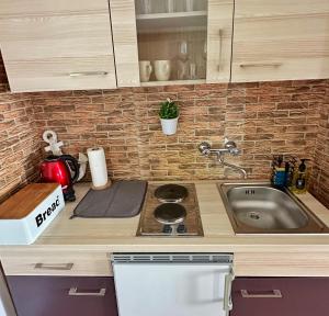 a kitchen with a sink and a counter top at Bajkoviti kutak 2 in Ogulin