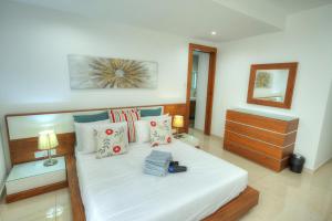 a bedroom with a large white bed with pillows at Large 3 bedroom with seafront balcony DDIF1-5 in Sliema