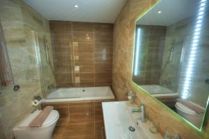 a bathroom with a tub and a toilet and a sink at Large 3 bedroom with seafront balcony DDIF1-5 in Sliema +20 photos