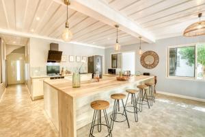 a kitchen with a large island with bar stools at Kaz Endemik in Saint-Paul