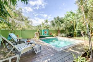 a backyard with a swimming pool and a wooden deck at Kaz Endemik in Saint-Paul
