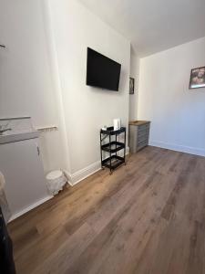 a living room with a flat screen tv on a wall at Wessex Guest House in Weymouth