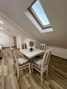 a dining room with a table and chairs and a skylight at Apartment Tri limuna 3 in Herceg-Novi +9 photos