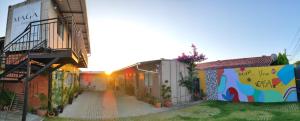 a building with a mural on the side of it at Maga hospedagem in Penha