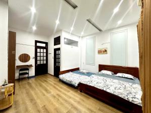 a bedroom with a bed and a desk at Tinahouse in Danang +6 photos