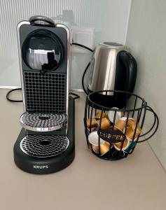 a toaster and a basket of bread on a counter at Studio Horizon Dorigny in Lausanne