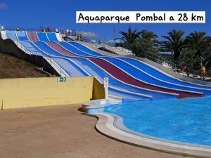 a row of water slides in a swimming pool at Casa DE Amigos in Ancião