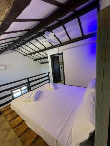 a bedroom with a large white bed in a room at Sunset Kite Village in Marsala