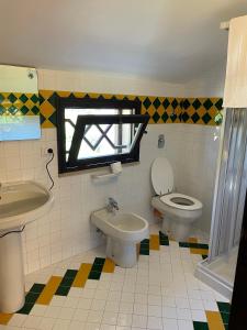 a bathroom with a toilet and a sink at Sunset Kite Village in Marsala +42 photos