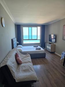 Ένα ή περισσότερα κρεβάτια σε δωμάτιο στο Sea Vacation