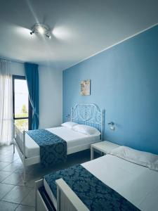 Postel nebo postele na pokoji v ubytování Hotel Achibea