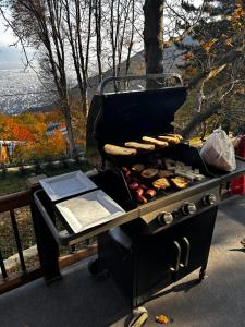 a grill with hot dogs and other food on it at Çalıkuşu Dağ Evi in Bursa