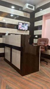 an office with a desk with a monitor and a chair at Hotel Miracle Stay in Bhubaneshwar