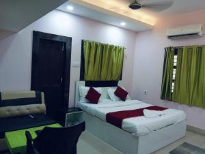 a bedroom with a bed and a green curtain at Hotel Miracle Stay in Bhubaneshwar